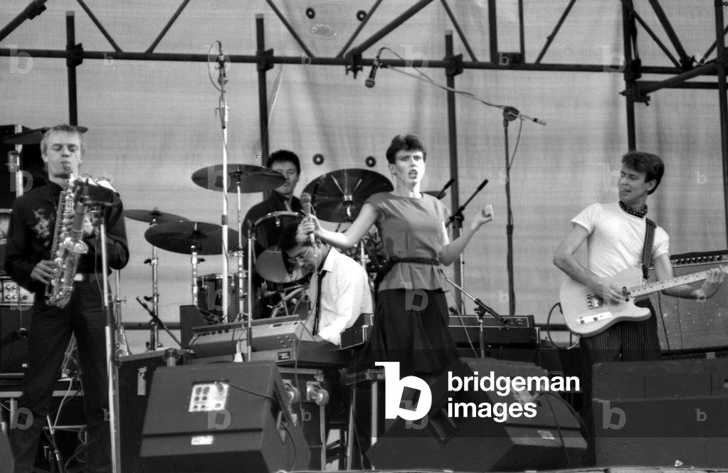 Hazel O'Connor performs on stage with her band Megahype at the outdoor concert in aid of racial harmony at The Butts stadium in Coventry, 22nd June 1981 (b/w photo)