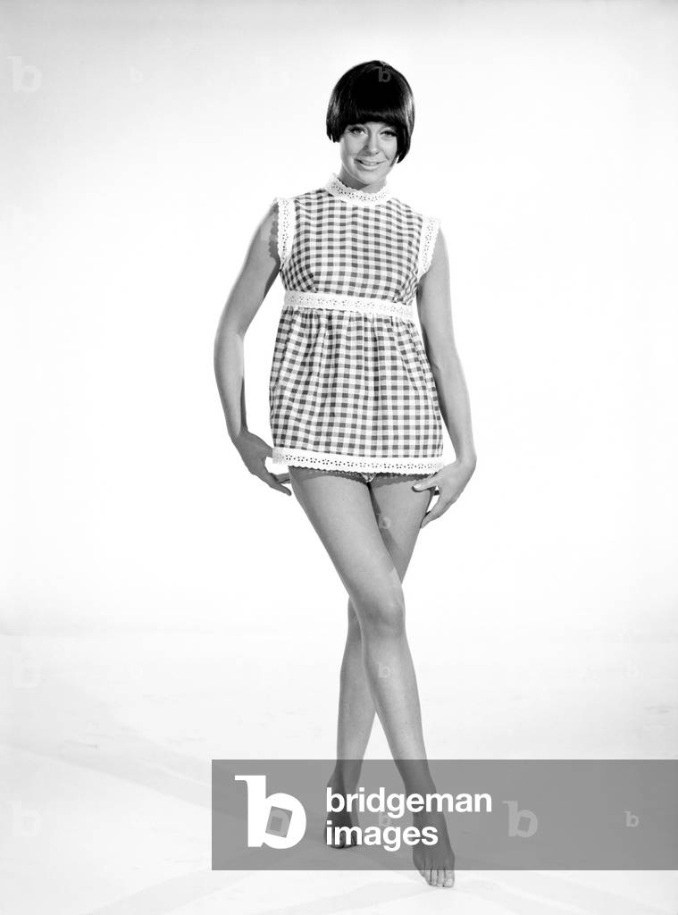 Clothing: Fashion: Dress: Woman wearing gingham dress. 1966 (b/w photo)