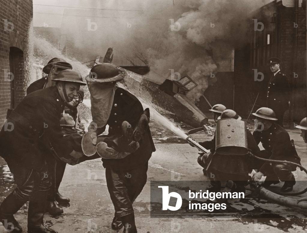 Ilford firemen giving a demonstration of an air crash tender during the Blitz (b/w photo)