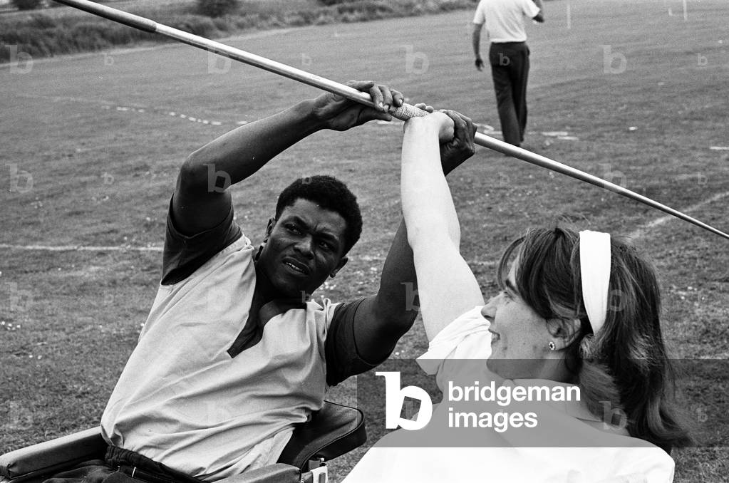 Paralympic Athletes training at Stoke Mandeville, watched by patients, ahead of the 1964 Paralympics to be held in Tokyo, pictured 22nd July 1964 (b/w photo)