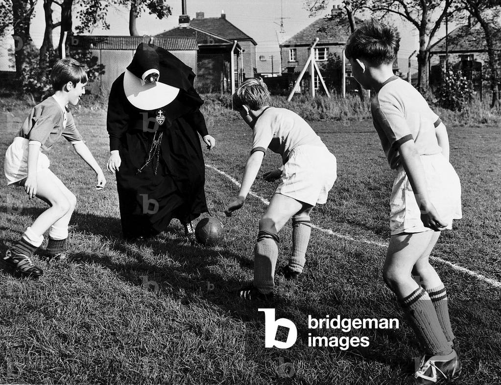 Sister John Gabriel deputy head mistress coaching the schools football team. 1965 (photo)