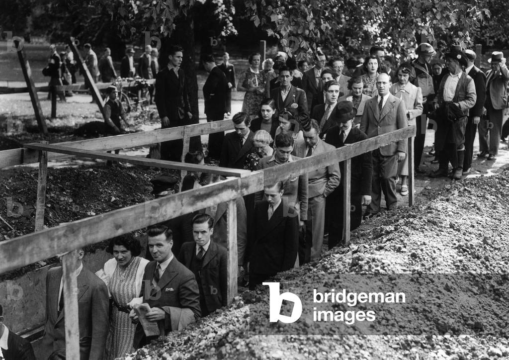 Crowds making their way down to an underground shelter as the air raid siren sounds, minutes after war has been declared, 3rd September 1939 (b/w photo)