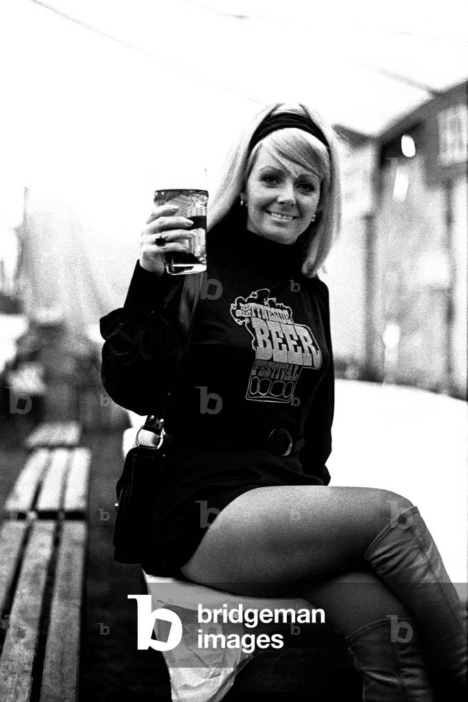 A young girl enjoying pint. The Tyneside Beer Festival at Gosforth, 22nd April 1973 (b/w photo)