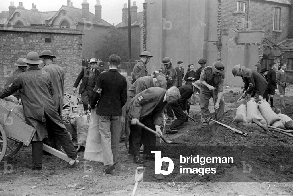 Alfieri. Fire Guards and ARP Wardens digging trenches for sand bag defences during Invasion Exercises, Kingston, London.
25th October 1942