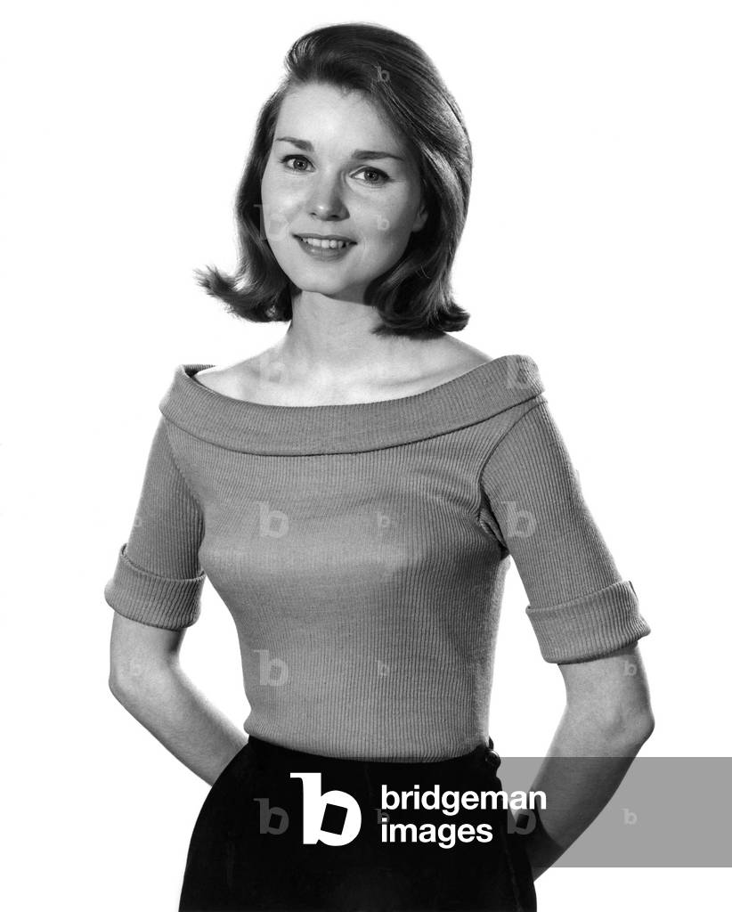 Model Helen Laundy wearing short sleeved top. 
April 1961