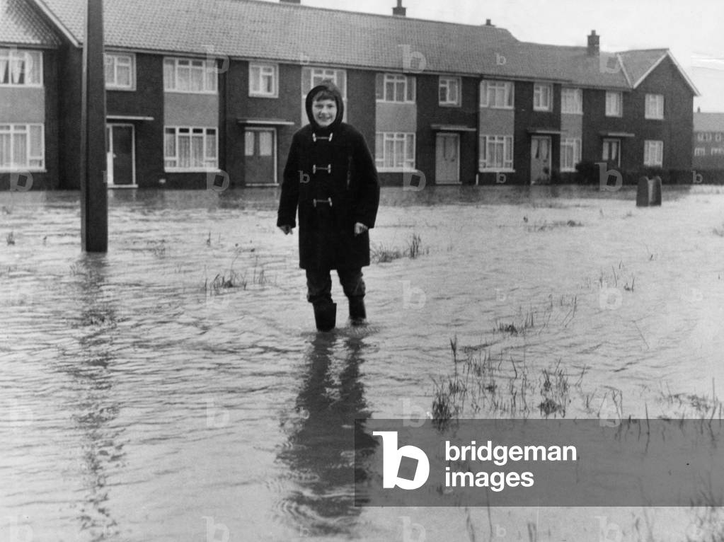 A local resident of Brambles Farm Middlesbrough makes their way through the flood water 2nd November 1968 (b/w photo)