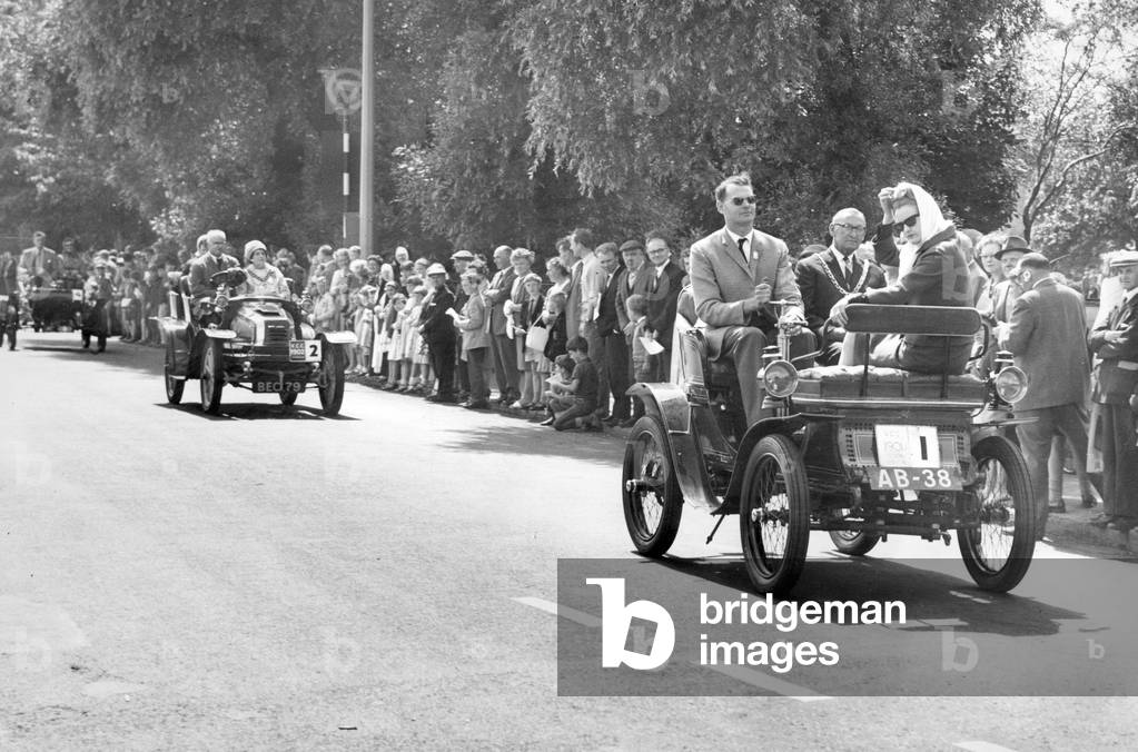 All 19 Veteran Cars due to take part in Saturdays veteran car pageant and rally, organised by the Middlesbrough Accident Prevention Council, arrive safely back in Middlesbrough after a 33 mile round trip to Saltburn. Crowds line the route at Redcar as Mayor Alderman Reg Thompson is pictured taking a ride in the oldest vehicle in the parade, a 1901 De Dion owned by Mr R H S Lung of Crowie, Lincolnshire, 31st July 1961 (b/w photo)
