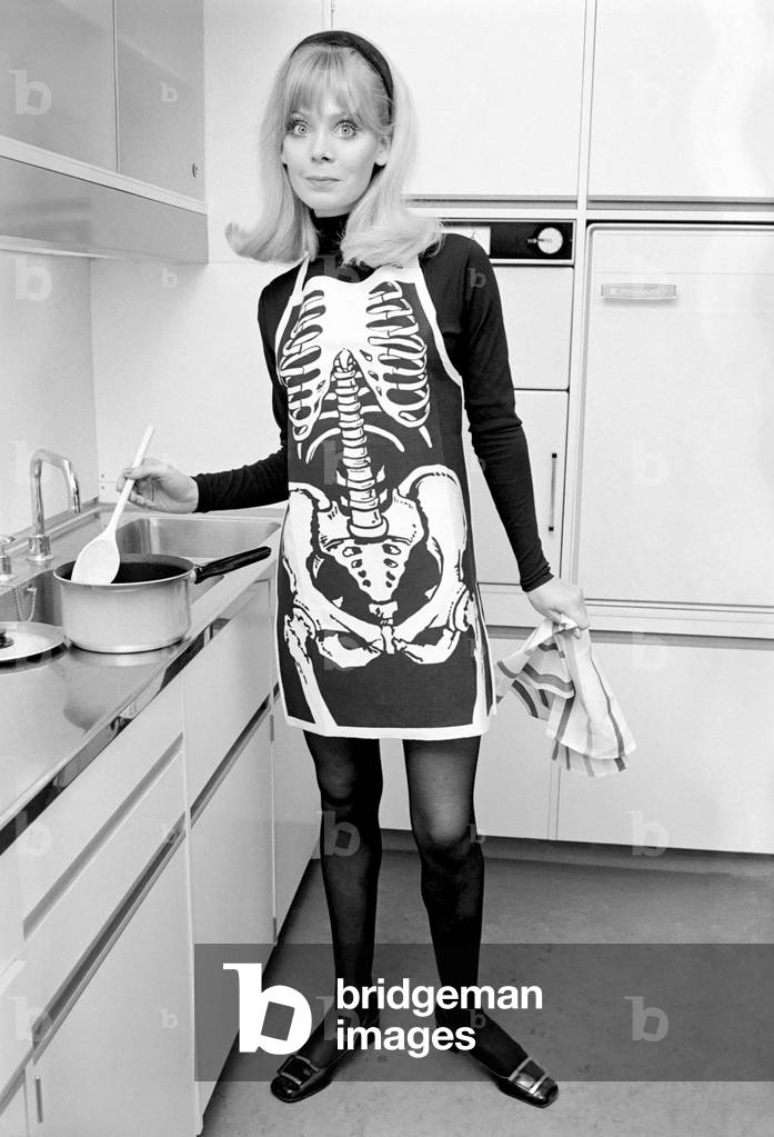 Model posing wearing a skeleton pinafore. December 1969