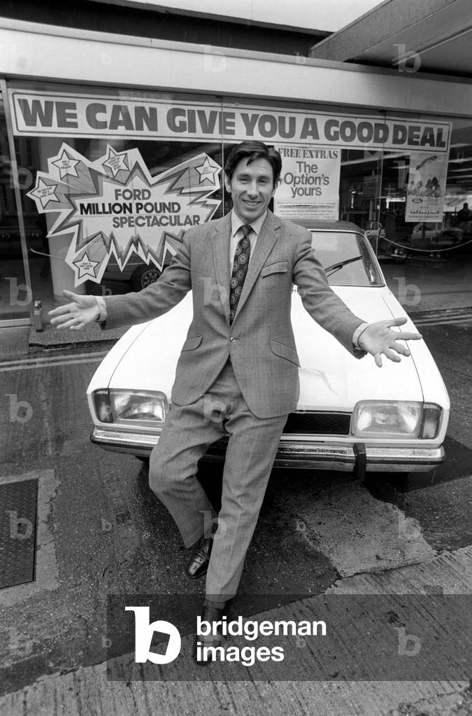 A car dealer putting cars on sale in his garage forecourt in Brighton, May 1975 (b/w photo)