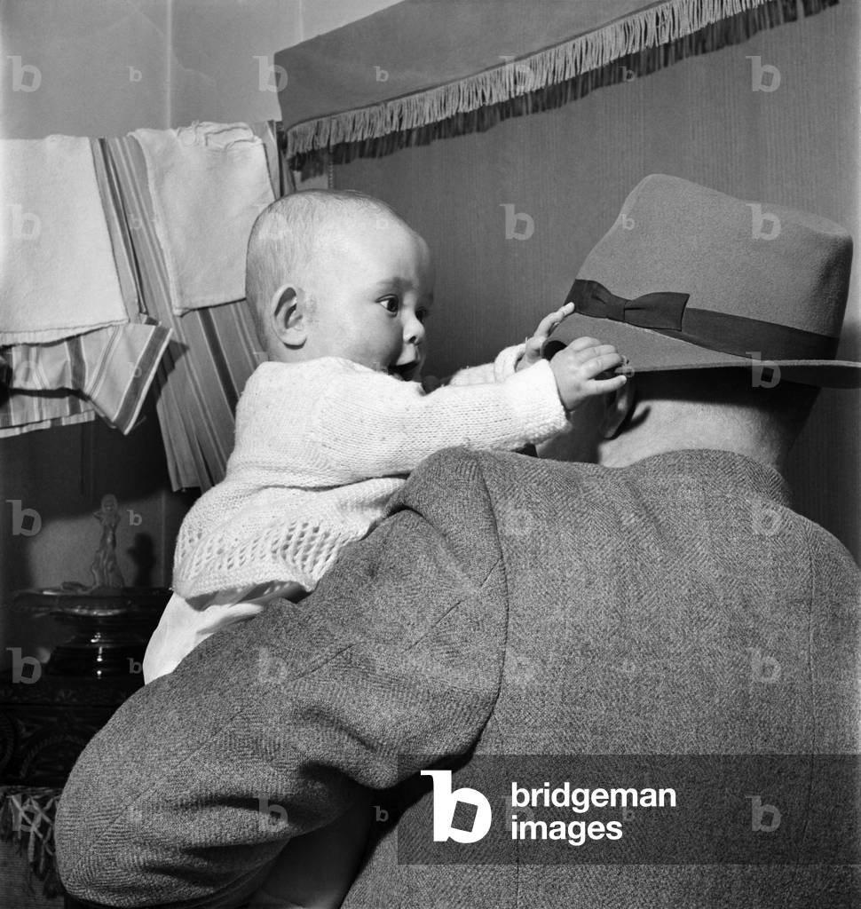 Baby Joy Sidy seen here playing with her father's hat. March 1953 D1398-001