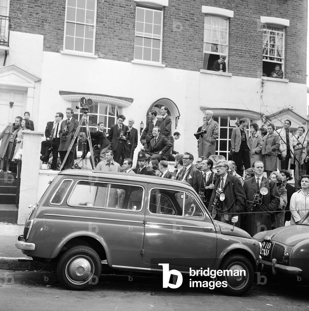 Photographers & journalists wait patiently for Brigitte Bardot, London, 1963 (b/w photo)