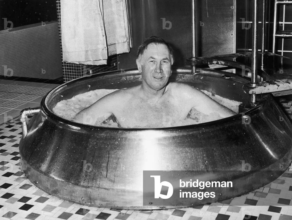 Joe Mercer the Manchester City manager seen here soaking in a tub at Blackpool sauna bath. 6th February 1969 (photo)