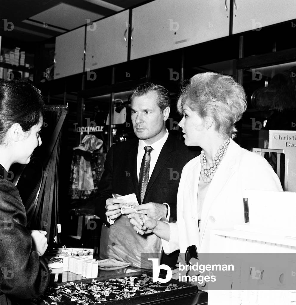 Theatre Critic Roderick Mann and Actress Kim Novak, pictured together at London Heathrow Airport, 16th July 1963.
