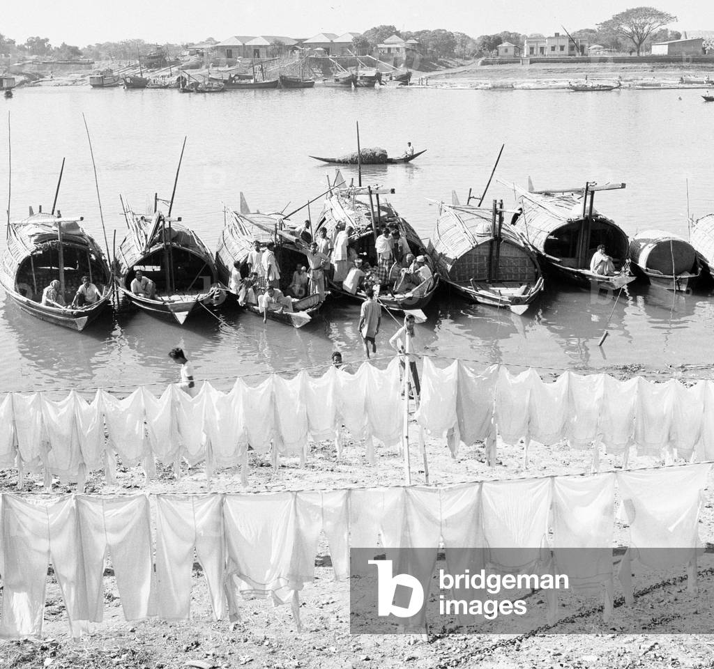 Boat people seen here hanging their washing out to dry on the muddy beach in Dacca, Bangladesh, February 1961 (b/w photo)