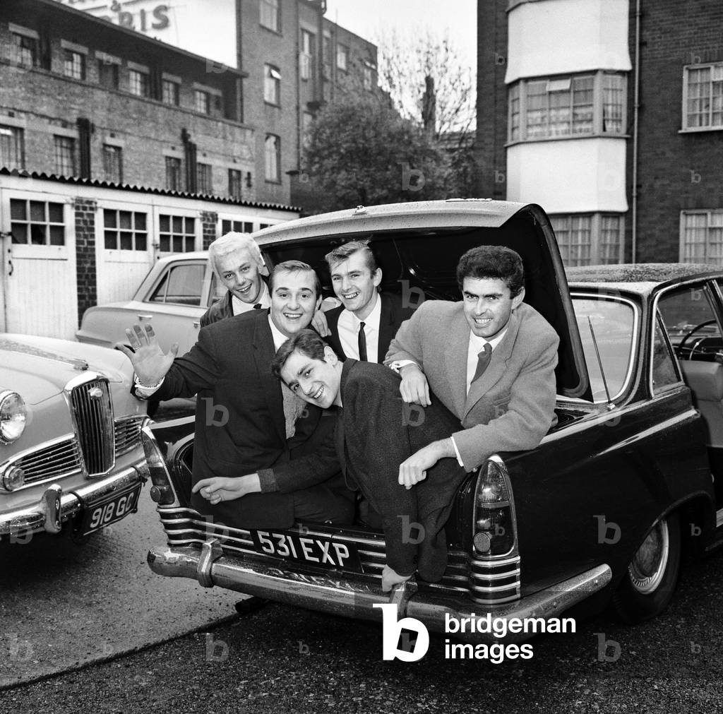 The five members of the Tornados pop group Heinz Burt, George Bellamy, Roger Lavern, Alan Caddy and Clem Cattini in the boot of Clem Cattini's new Zodiac car. 7th November 1962 (b/w photo)