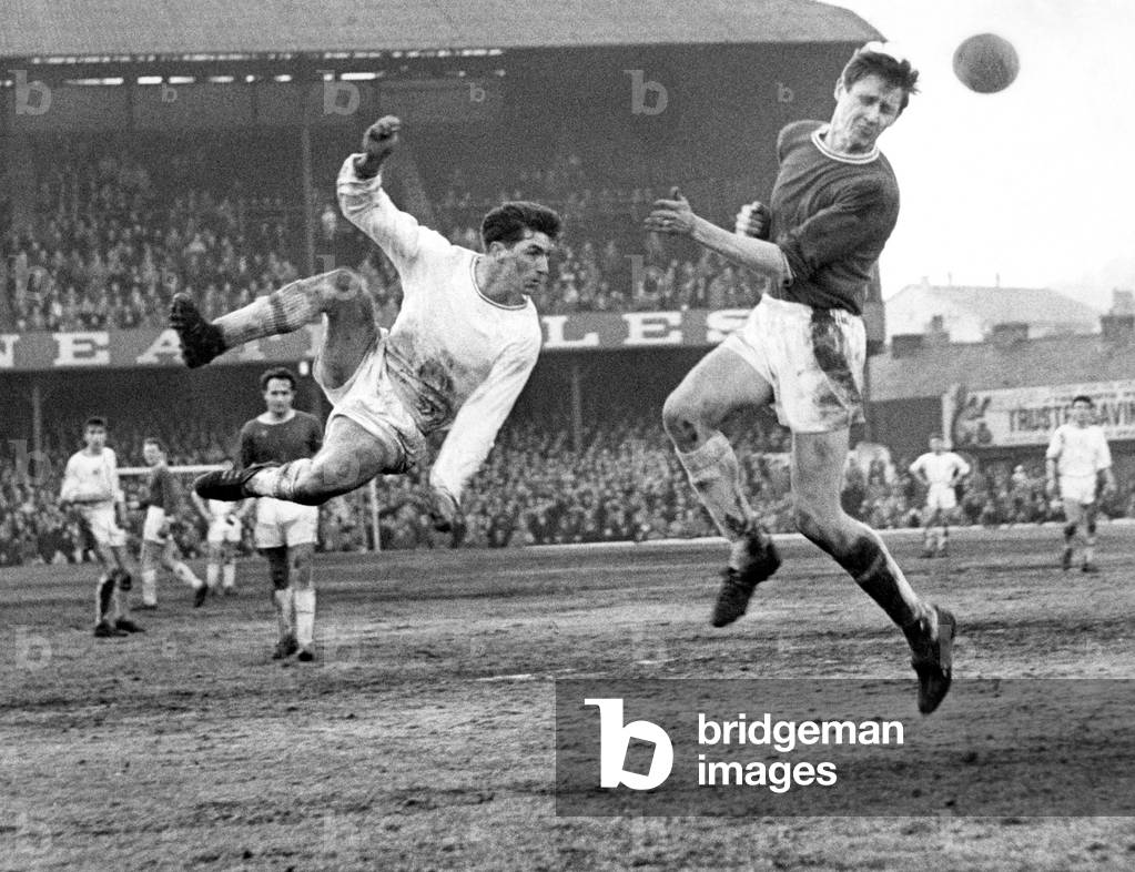 Swansea Town player Brayley Reynolds takes a flying leap but is beaten by Queen's Park Rangers Mike Keen during the FA Cup match at Vetch Field. 26th January 1963 (photo)