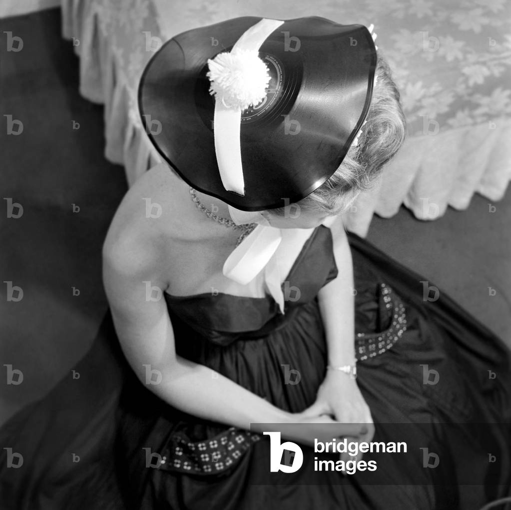Clothing: Fashion: Humour singer Diane Decker seen here wearing a hat made out of old records. July 1953