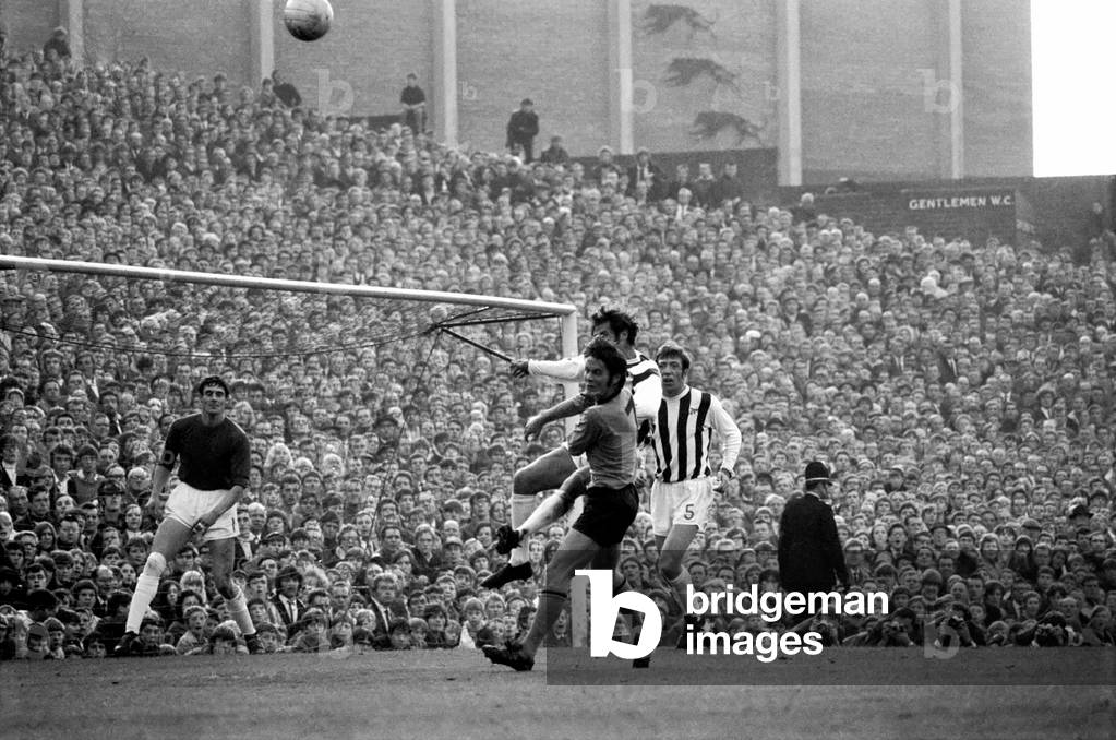 English League Division One matchWolverhampton Wanderers 1 v West Bromwich Albion 0. Wolves Jim McCalliog is foiled as Albion's Fraser heads away the ball from the Albion net watched by team mate Talbut. November 1969 (photo)