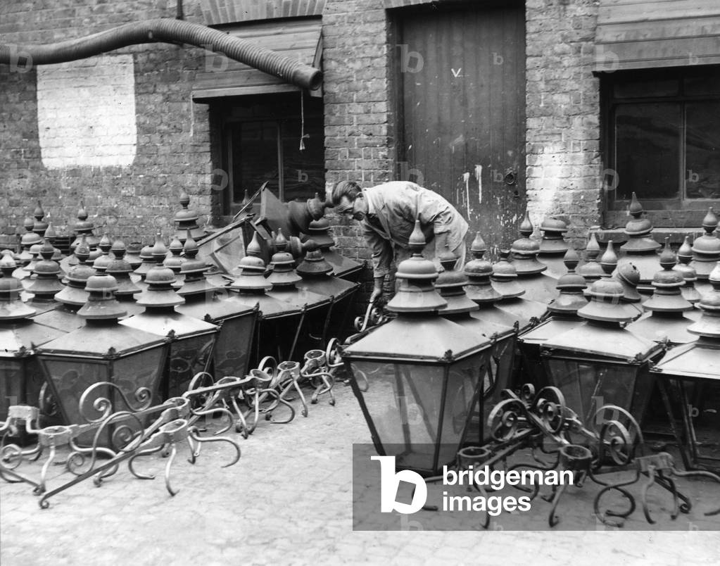 Mr Mack, the Lighting Inspector for Hornsey Borough Council, with some of the hundreds of street gas lamps being maintained and overhauled at the Borough's depot, in readiness for the total lifting of the blackout.
19th September 1944
