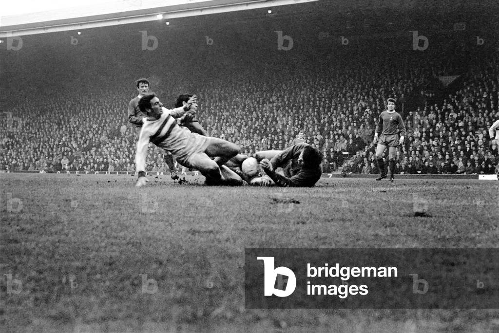 English League Division One match at AnfieldLiverpool 2 v West Ham United 0. Tommy Lawrence, Ron Yeats and West Hams Trevor Brooking collide together whilst going for the ball. November 1969 (photo)