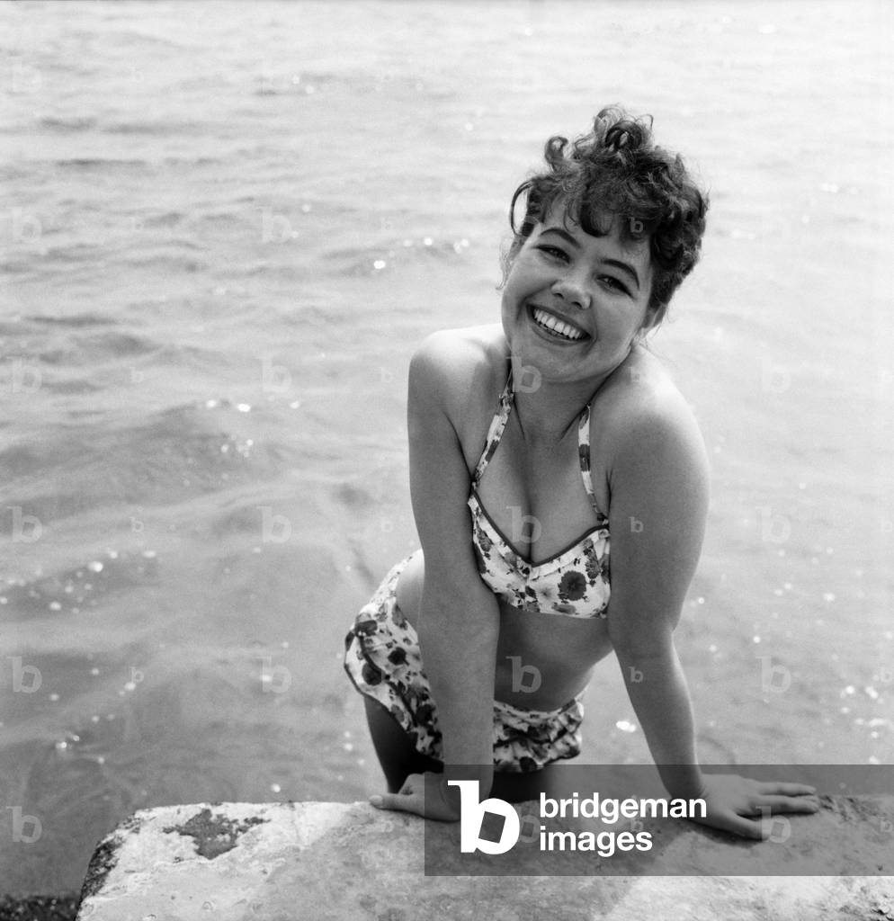 Bathing Girl: Glamour on the Clacton Beach: The cheeky smile belongs to Maureen Kenn, 21, a Waitress from Clacton. June 1960