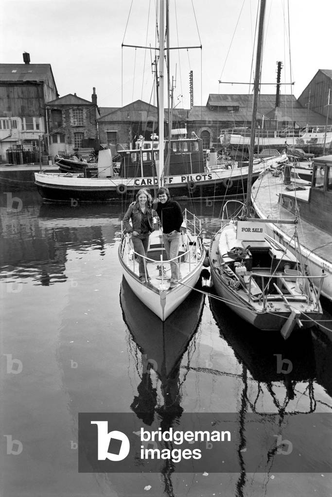 Young couples round the world voyage. Jane Owen aged 23 of Cardiff and Geoff Burrel, age 25 of Portsmouth on board the 'Roris' a 28ft. sloop - at Barry Docks, Glam, March 1975 (b/w photo)