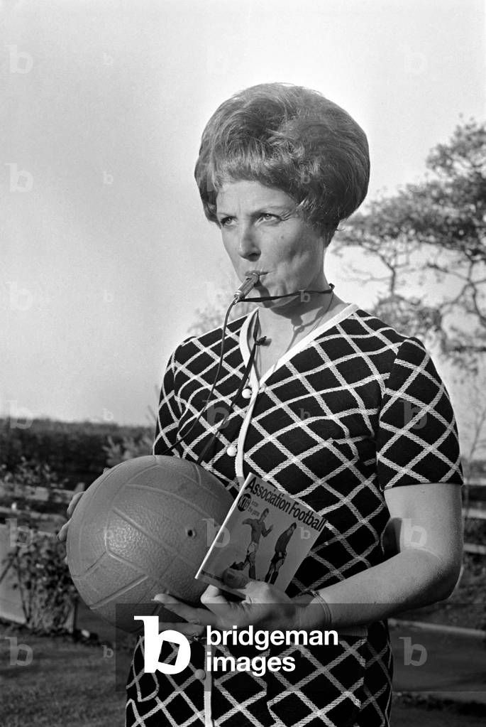 Trainer-coach of the Ashton Junior Football club is ex-model Bobbie Leigh, and during training sessions with the players she carries a rule book, for she is a youth club leader and new to the game of soccer. Close ups of Bobby with ball, whistle and rule book. November 1969 (photo)