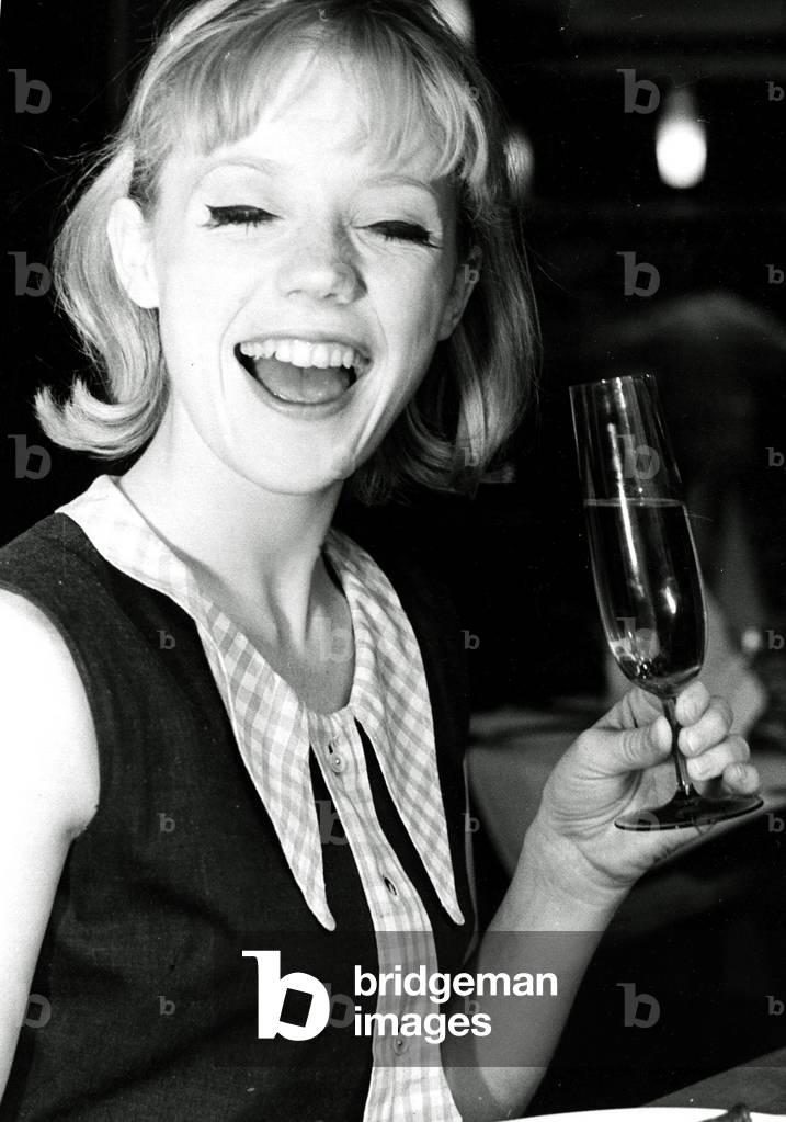 Geraldine Sinclair using new cutlery and glasses at the Steak Encore restaurant Leicester Square, July 1963 (b/w photo)