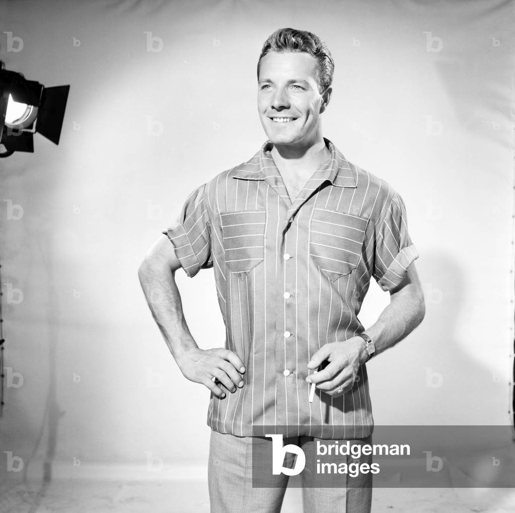 Man wearing shorts sleeve shirt. 1960