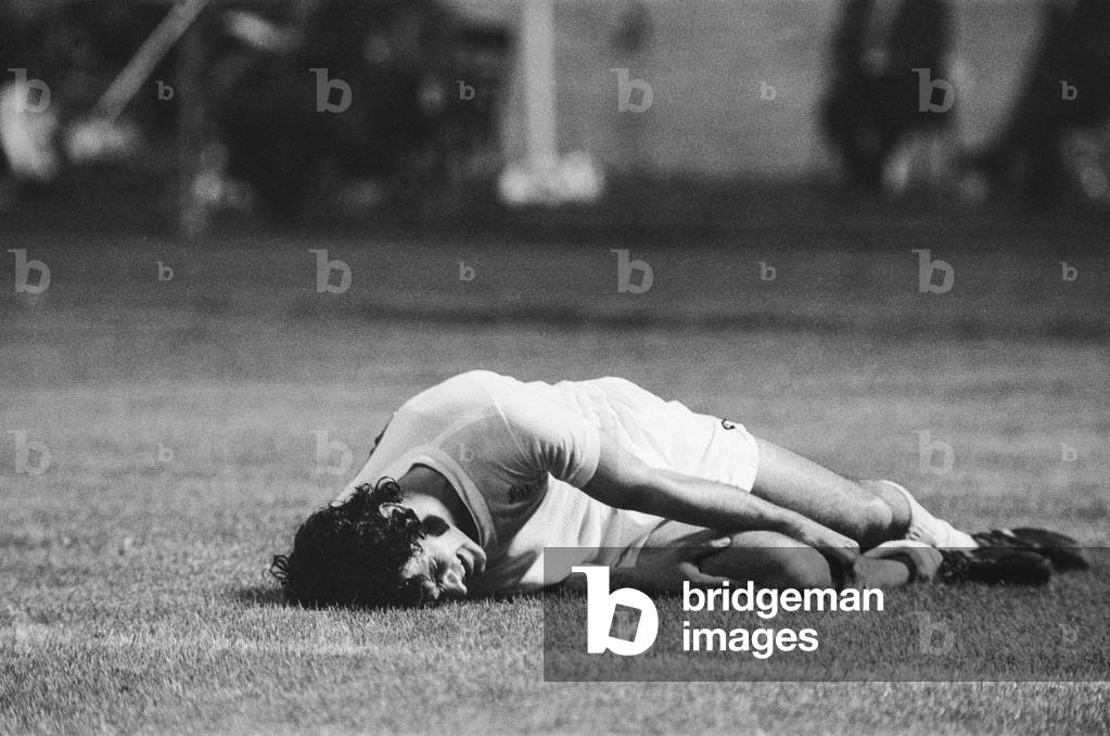 1973 European Cup Winners Cup Final at the Kaftanzoglio Stadium in Thessaloniki, Greece. AC Milan 1 v Leeds United 0 Picture shows: A Leeds player down injured. During the match Leeds had goals disallowed, several penalty appeals rejected and a player sent off by Greek referee Christos Michas and lost the game to an indirect free kick taken directly. Michas was later convicted of match fixing in a Greek court and was fined, sent to jail and banned by UEFA from refereeing for life. 16th May 1973 (b/w photo)
