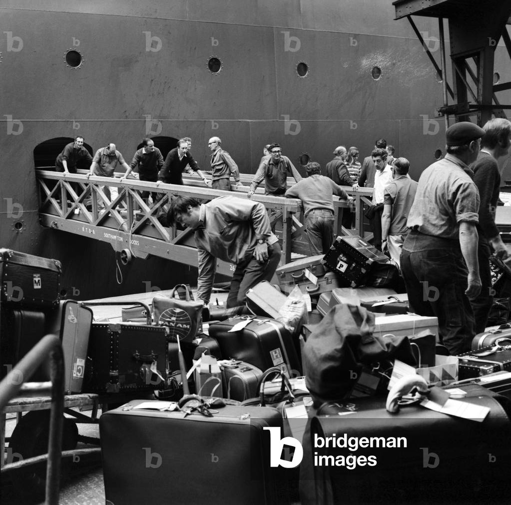 Southampton Docks: Shore and office staff of Cunard, loading baggage onto Q.E.2 at Southampton. She sails for New York at 12.30 p.m. today. July 1970