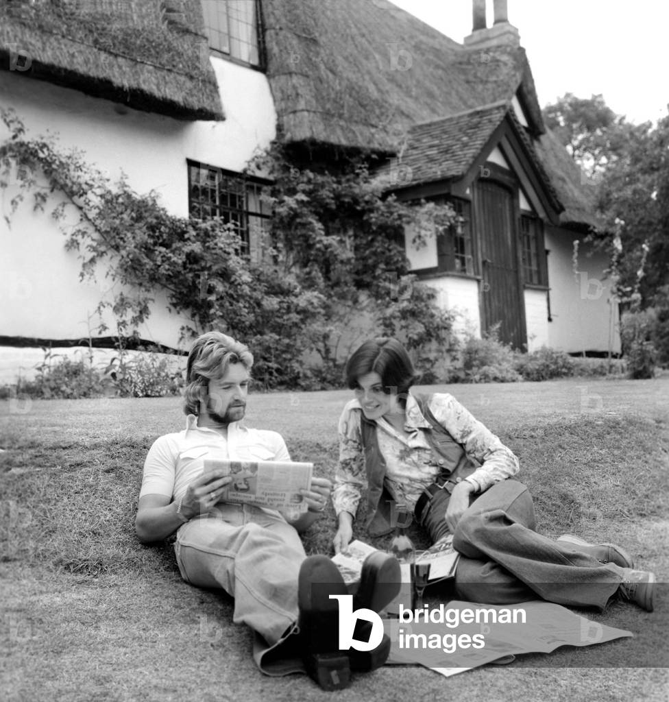 Noel Edmonds and his wife at home relax in the garden, September 1976 (b/w photo)