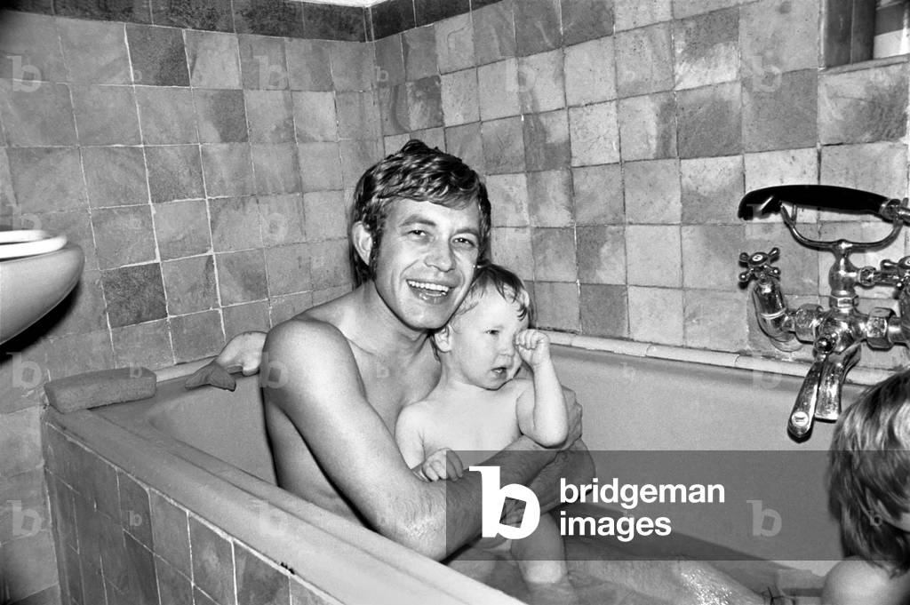 Families: Mother, father and children. Father in the bath with baby boy and son. November 1969
