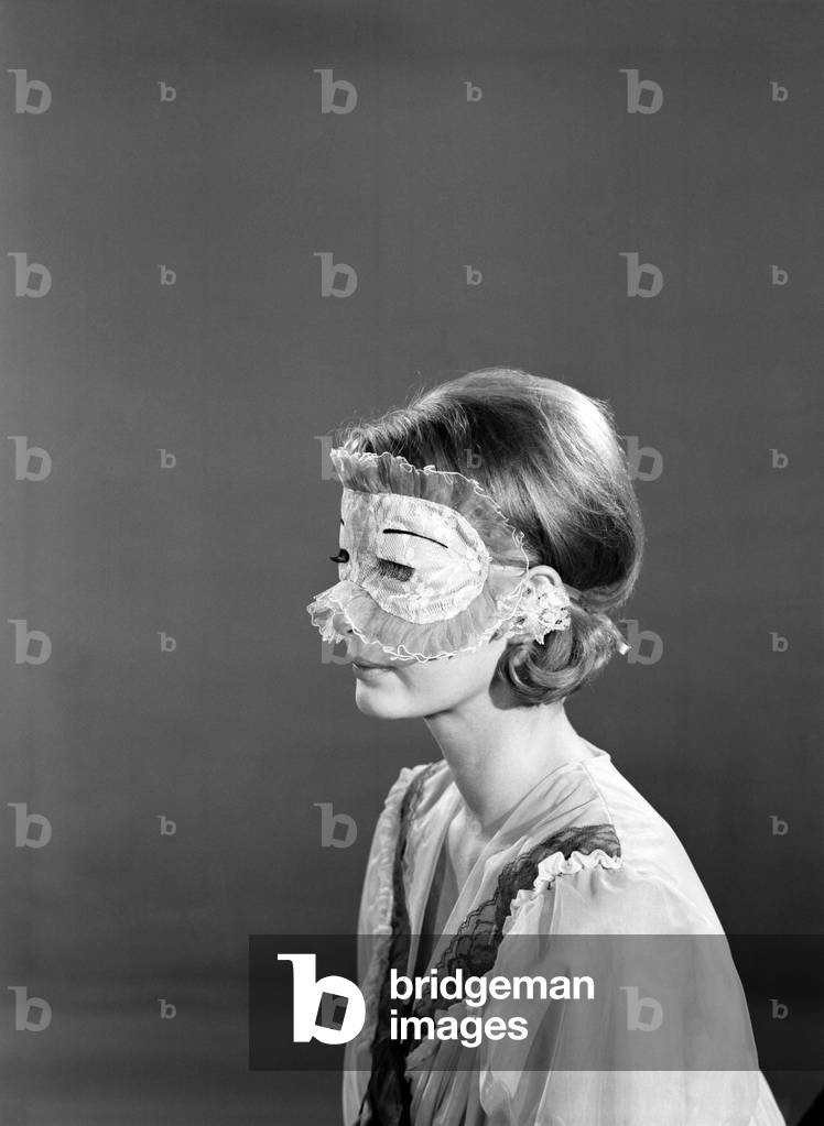 Model Dawn Chapman wearing face mask to aid her in getting a good nights sleep, 1962 (b/w photo)