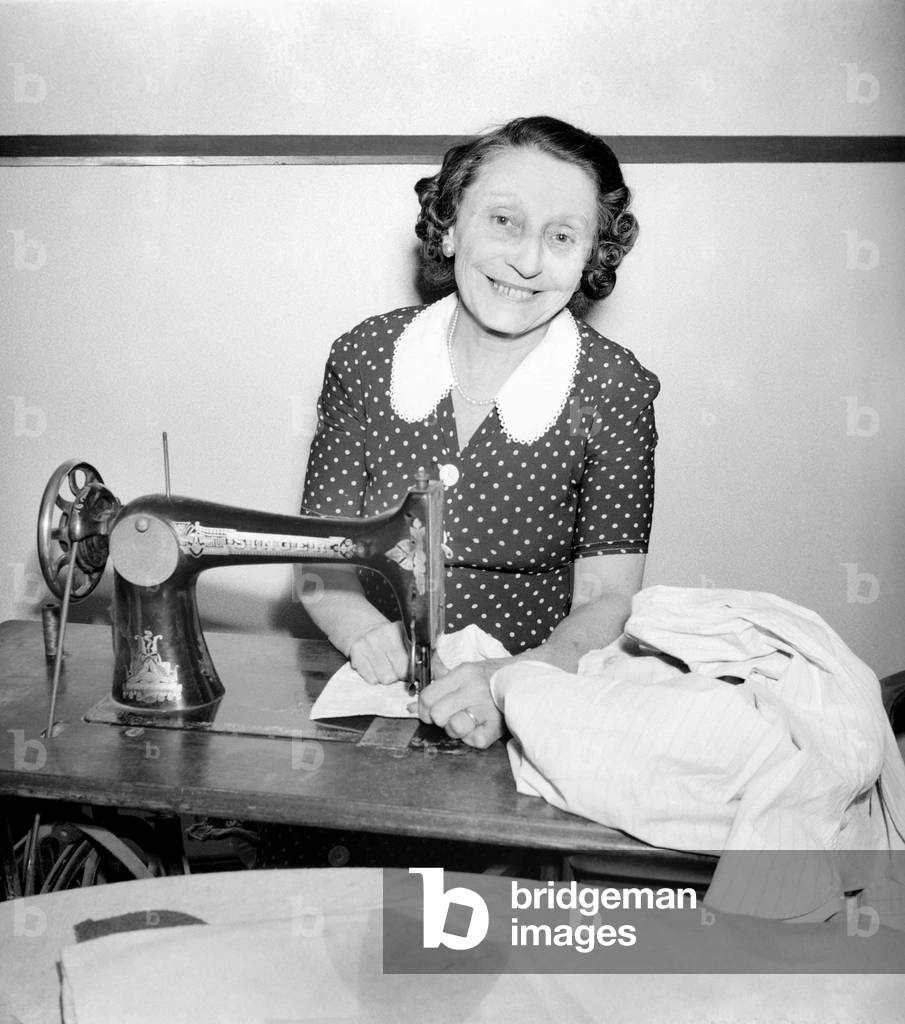 Woman with sewing machine. September 1953