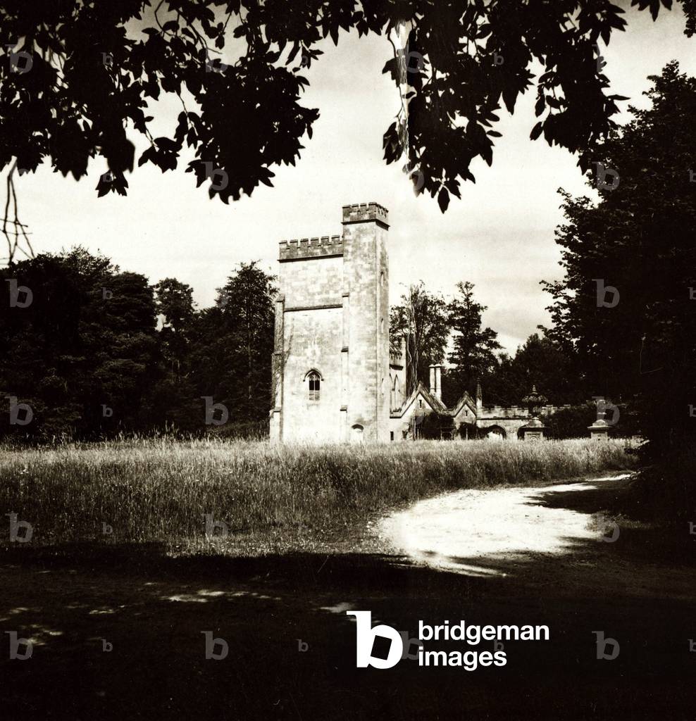 a dusty road leading up to a castle like building - Trees overhanging - Shadows, c. 1930 (b/w photo)