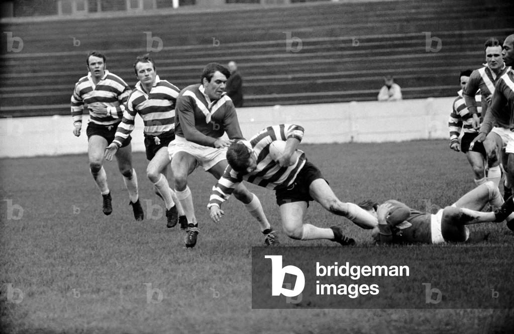Leigh v. Oldham. Oldham centre Beverley is tackled by Leigh forward Lyon and stand-off Eckersley. November 1969 Z11533-009