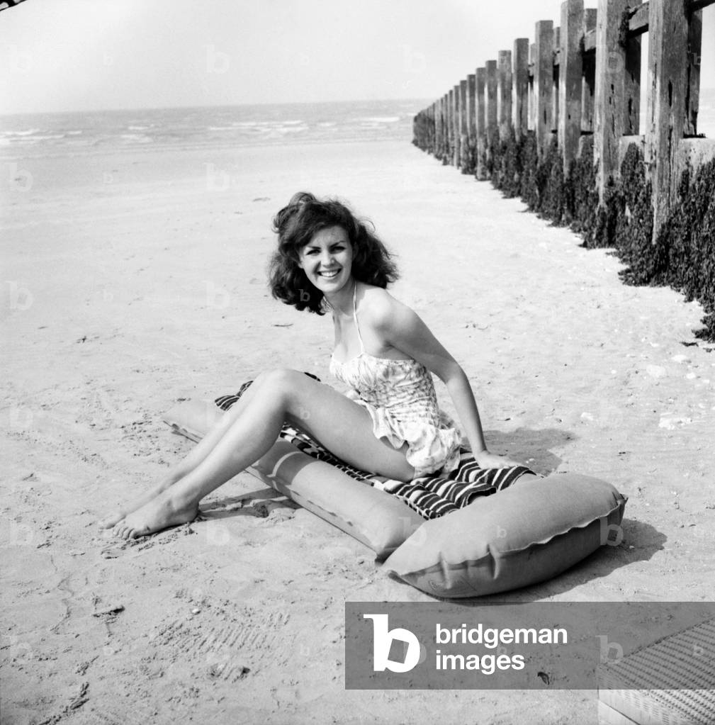 Beach Glamour: Having holiday fun in the sun at Minnis Bay near Margate, Kent. are girl with dark hair (A red head) Beverley Bennett age 18 and Blonde Ingrid Young age 16 both girls are actresses at the Adia Foster School. June 1960