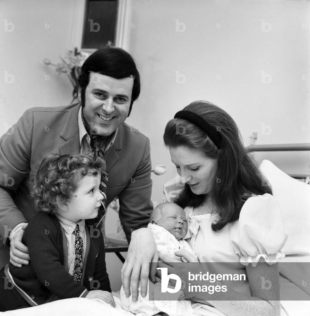 Proud father Terry Wogan allowed news crews to document his visit to Queen Charlotte's Hospital as he brought his eldest son Alan Wogan, 2½, to visit his mother Helen Wogan and new born baby brother aged just two days old, 15th April 1970 (b/w photo)