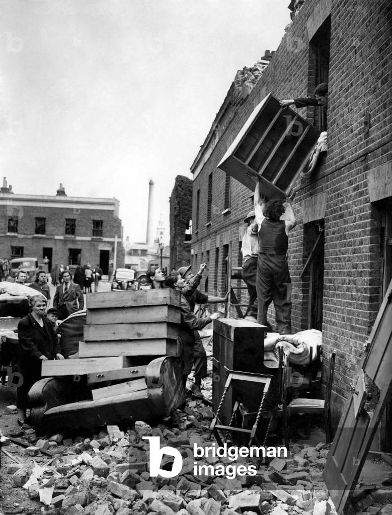 Removing furniture from a top room in Deptford. June 1944