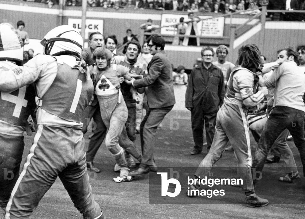 This was the scene at Belle Vue after an amazing flare-up in the Aces match against Leicester. Here Leicester skipper Ray Wilson (No1) holds his team-mate Alan Cowland (No 4) while officials restrain Belle Vue rider Alan Wilkinson. 11th July 1971 (b/w photo)