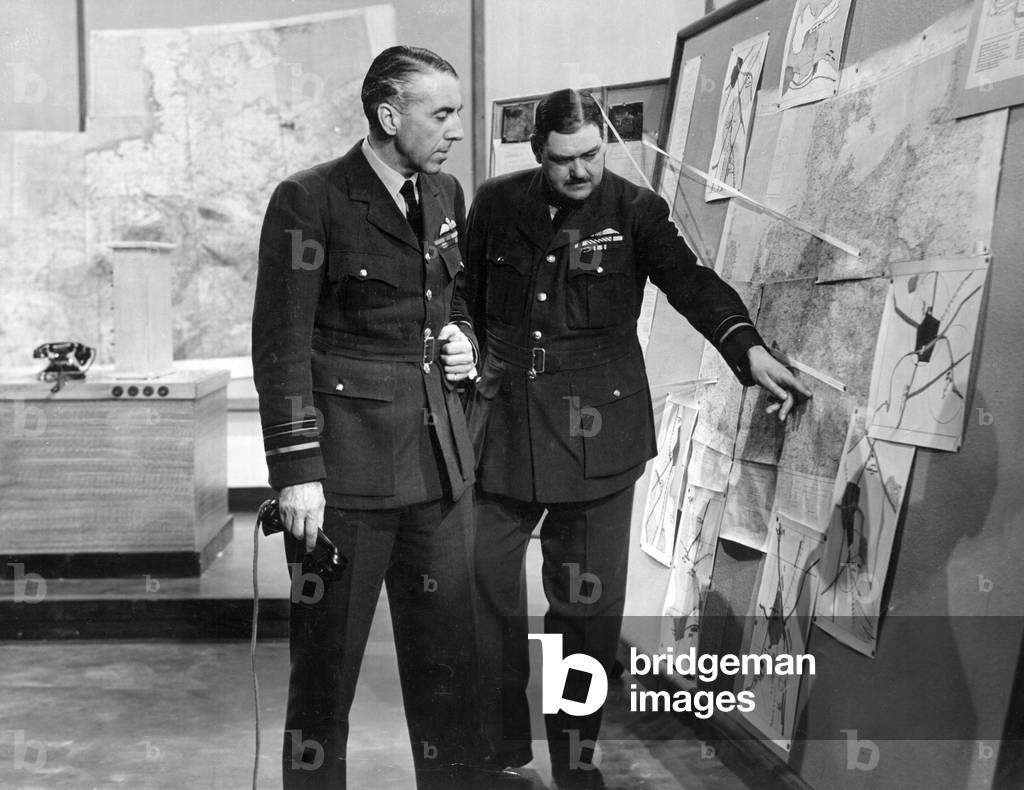 Air Marshal Sir Richard Peirse, Commander in Chief of RAF Bomber Command discussing a target with his chief of staff during preparations for a raid in world War Two. September 1941.