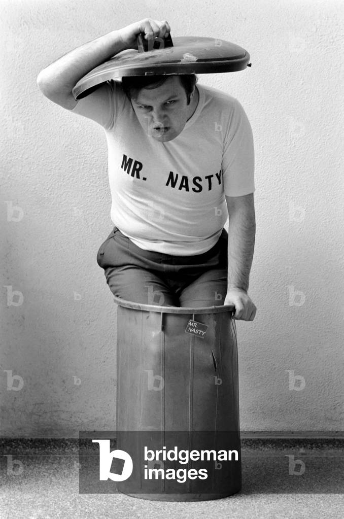Mr. Nasty: Mr. Nasty, alias broadcaster John Forrest (25) who conducts Britain's only phone-in for children each Sunday morning on London Broadcasting. John Forrest pictured at home in his dustbin, March 1975 (b/w photo)