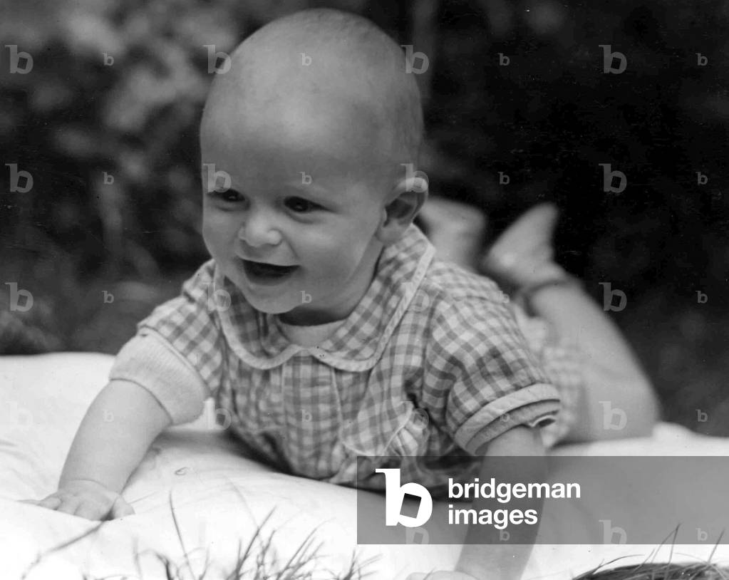 Young baby crawling around on the mat in the back garden
Circa 1945