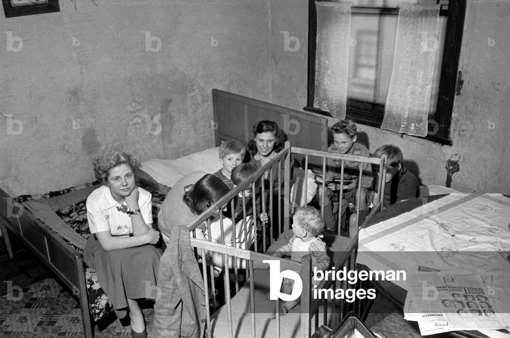 Crowded home. Slums in Paddington - condemned house with no lavatory. October 1953