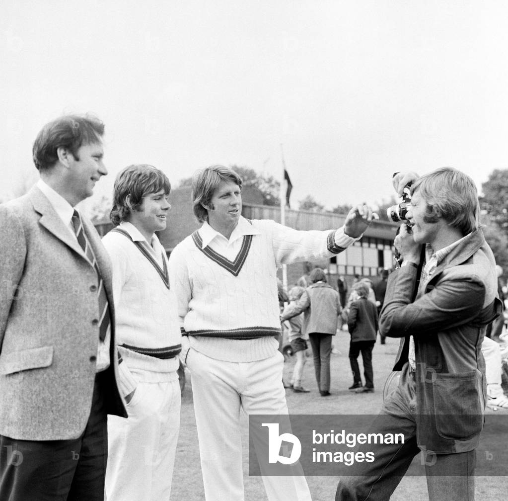 The touring Australian test team in England, visiting Southgate cricket club ahead of the Ashes test matches. One of Southgate's members Ross Collins snapped the chance to get a picture of fast bowler Jeffrey Thomson (far right) and Jim Higgs (centre) with Southgate captain Jim Conroy (left). 4th June 1975 (b/w photo)