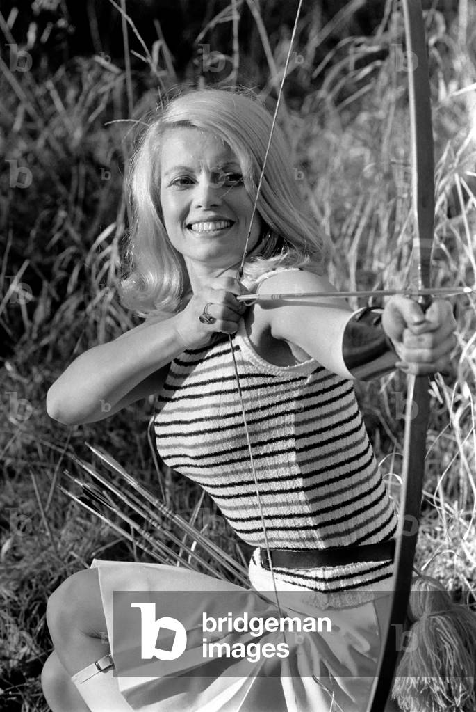 Glamour model Lyn Mason seen here getting her eye in with her bow and arrow . January 1971
