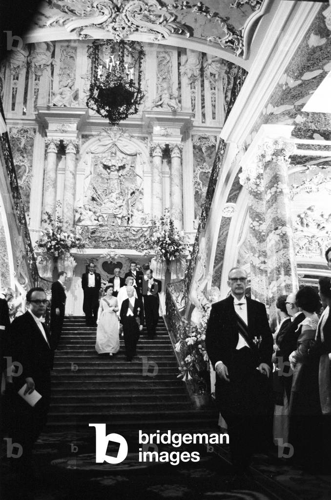 Queen Elizabeth II leading a procession down the fantastic staircase of Augustusburg Palace in Bruhl, during her visit to West Germany. 18th May 1965 (b/w photo)