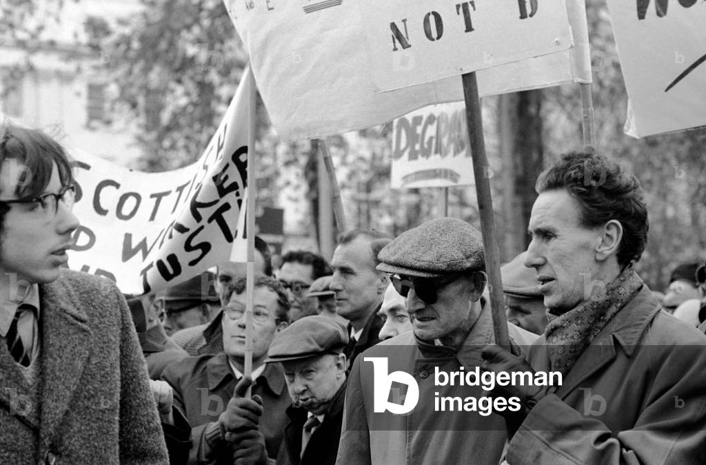 Hundreds of blind workers today staged a protest in Belgrave Square, London, for better wages. They want an increase of £1.5. a week on the £14.5s. Basic pay of 3,500 blind workers. At No. 41, Belgrave Square, a meeting was being held to discuss their wage claims. The Blind workers with their placards during the protest in Belgrave Square. November 1969