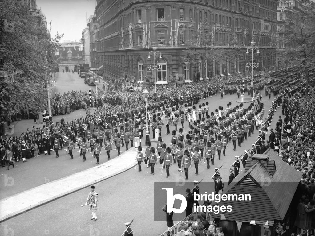 The Band and Corps of Drums of the Welsh and Irish Guards march down Northumberland Avenue ahead of the gold state coach carrying the Queen to Westminster Abbey for her coronation 2nd June 1952 (b/w photo)